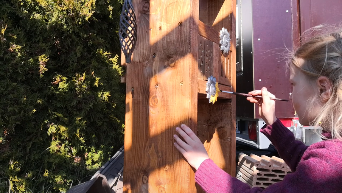 4.2. Bug Hotel - Painting - first coat - yellow color  on sunflowers.png