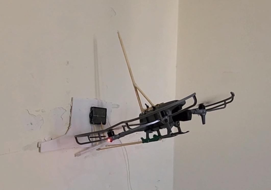 6_DroneAttachDeviceToWall.jpg