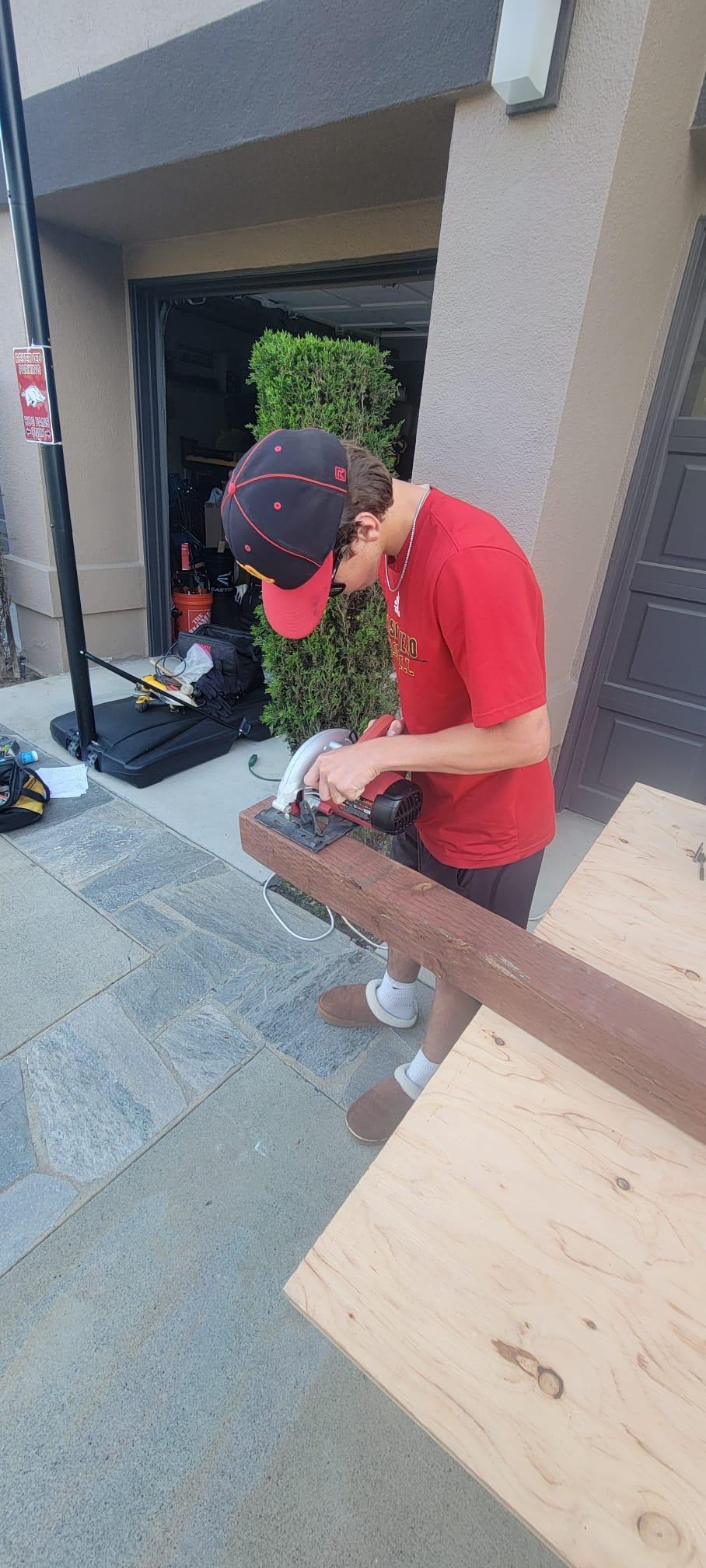 Cutting the Feet of the House with a circular saw.JPG