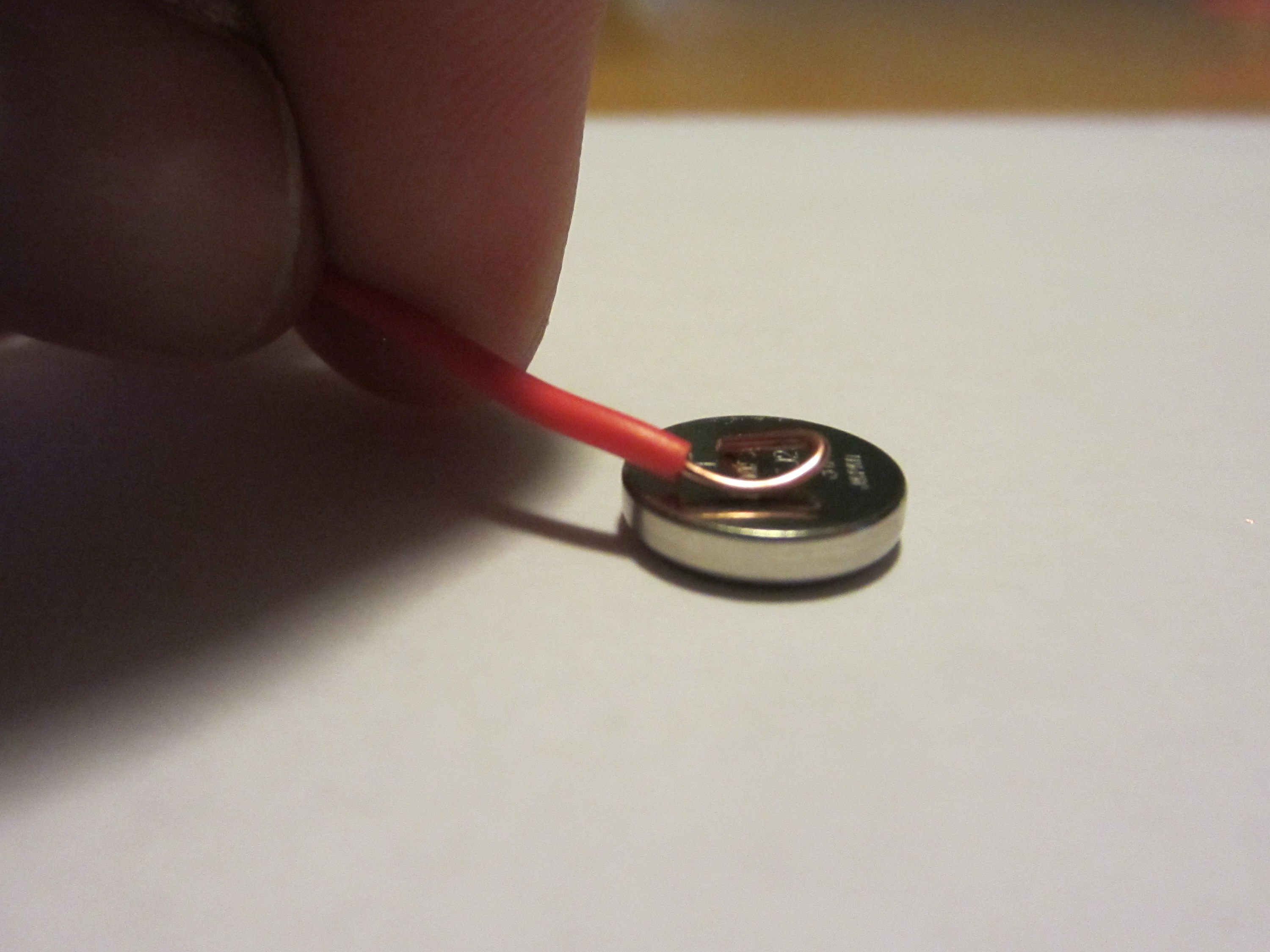 HeatShrinkCoinButtonBatteryHolder-InsertWireRed.JPG