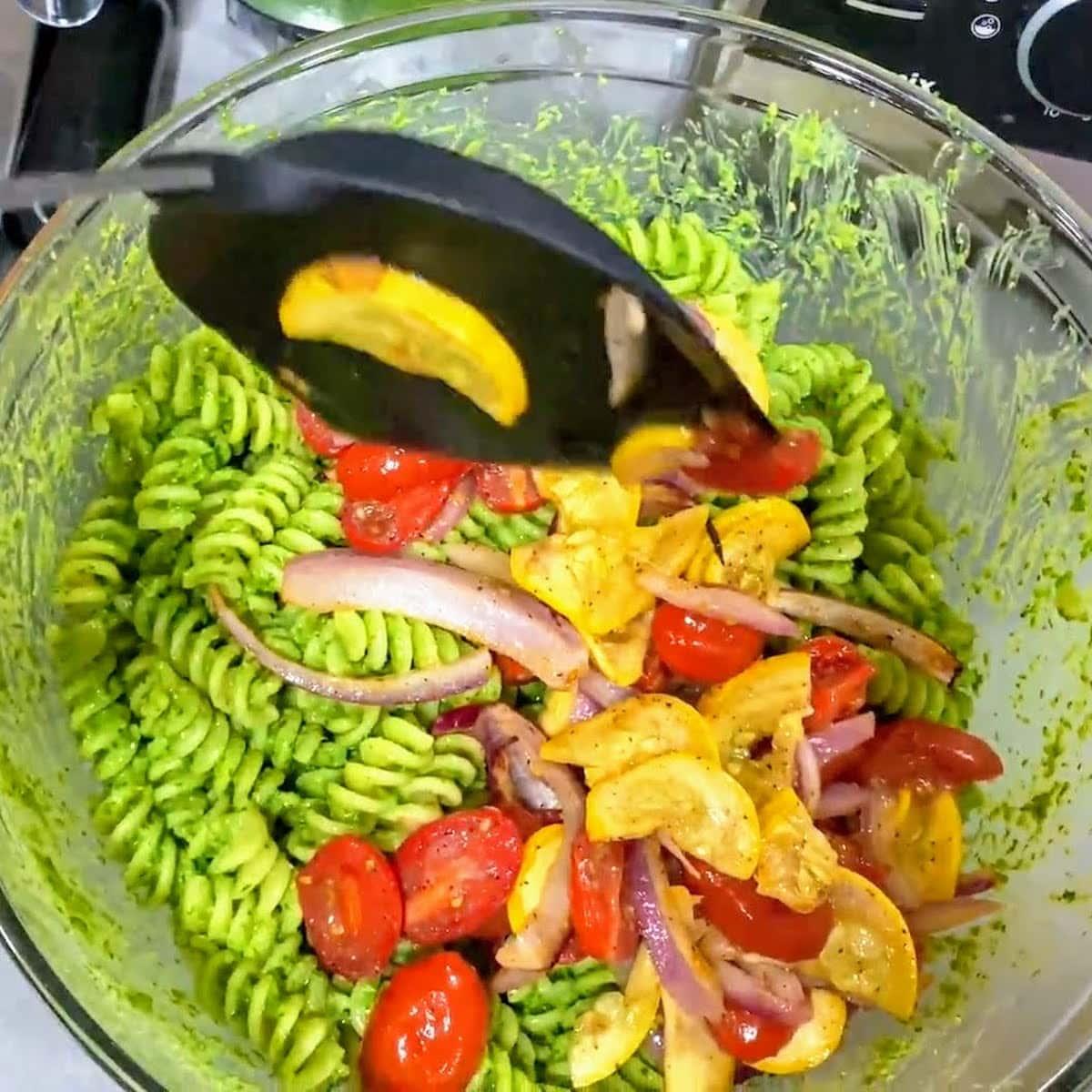 adding-veggies-to-pesto-pasta.jpeg