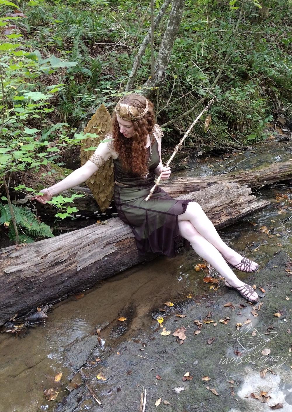 forest fairy sitting on log in creek.jpg